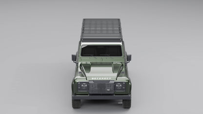 Direkte Frontansicht eines dunkelgrünen Land Rover Defender 110, die das flache, aerodynamische Profil des schwarzen Expeditions-Dachträgers zeigt.
